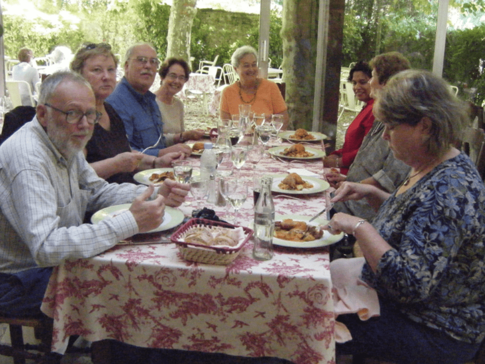 Lunch in the garden of the Hotel Cro-Magnon during a small group gourmet tour of France with Olde Ipswich Tours.